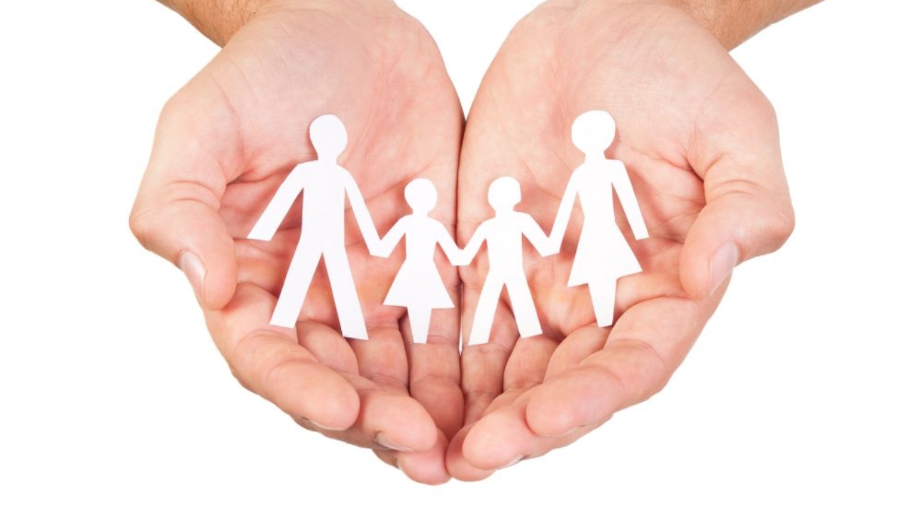 Paper family in hands isolated on white background